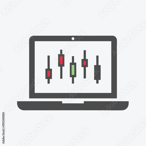 Candlestick charts displayed on grey laptop screen indicate volatile stock market trends visibly