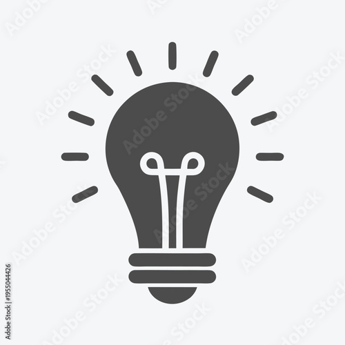 Simple light bulb shines brightly radiating light with energy, symbolizing an innovation or idea