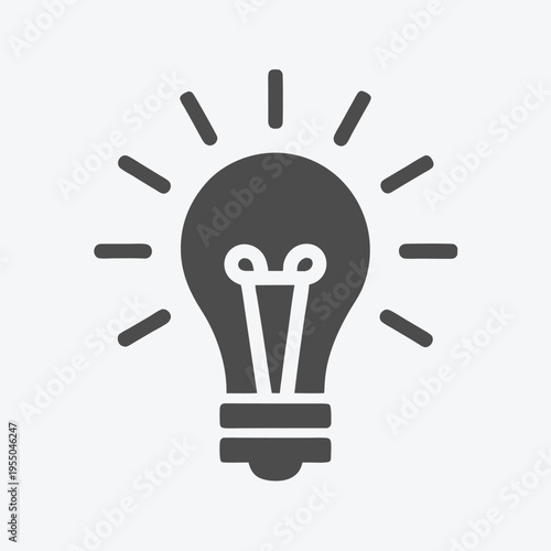 Light radiates brightly from the center of a dark gray bulb, symbolizing ideas