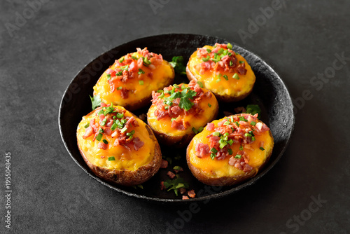 Homemade baked stuffed potatoes with bacon, green onion and cheddar cheese