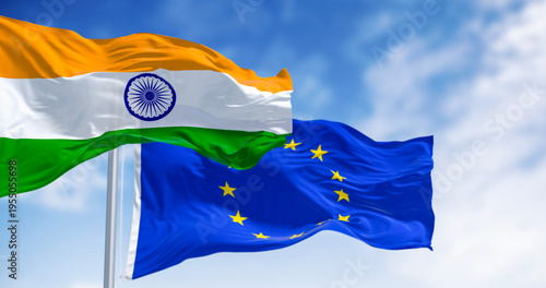 Flags of India and the European Union waving on a clear day