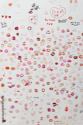 Colorful lipstick kiss marks on white wall, love and beauty concept background