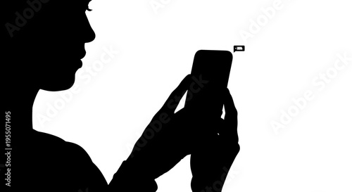 Silhouette of a Person Using a Smartphone with Low Battery Icon
