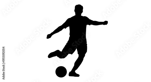 Silhouette of a Soccer Player Kicking a Ball