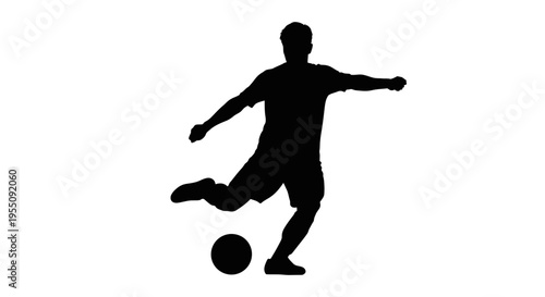 Silhouette of a Soccer Player Kicking a Ball