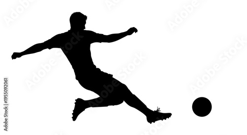 Silhouette of a Soccer Player Kicking a Ball