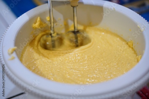 Wallpaper Mural Process of making cake batter using an electric mixer and flour sifter, representing baking activity in a home kitchen. Torontodigital.ca