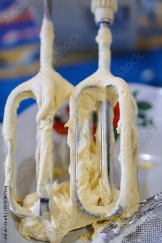 Wallpaper Mural Close-up of cake batter sticking to mixer beaters, showing soft texture and baking process in the kitchen. Torontodigital.ca