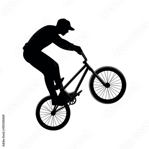 Dynamic bmx rider performing a wheelie trick on a bicycle in a striking black silhouette