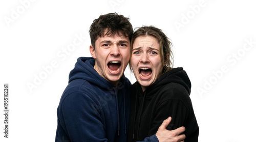Two young adults wearing hoodies screaming excitedly together isolated on white background with arms around each other