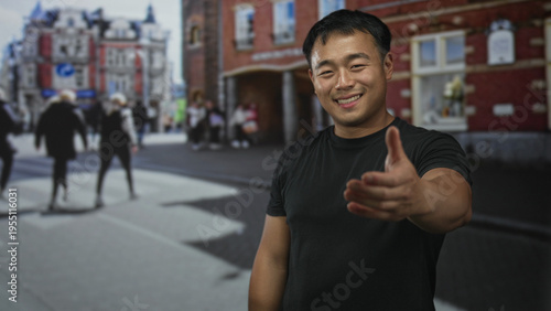 Slika na platnu Man extends hand for handshake on a busy city street with blurred pedestrians behind him; friendship
