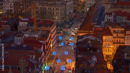 People tourists walking on street next to european style buildings, lit up by building lights at night and colorful street light decorations over cars driving no road