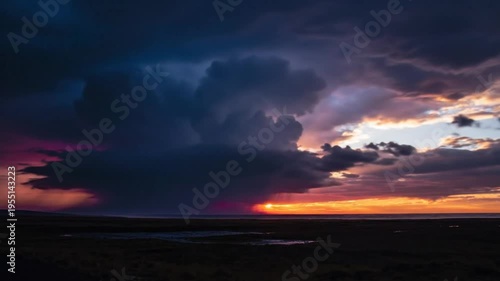 Epic sunset scene with dramatic clouds, vibrant colors, and sun rays beaming through stormy skies above the ocean and landscape