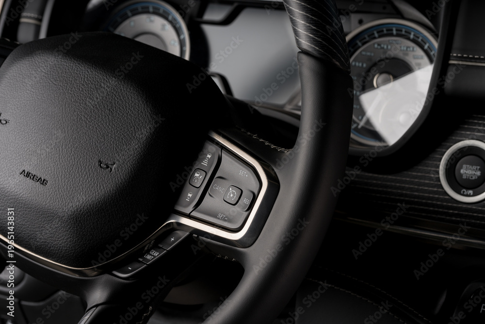 Obraz premium New car interior steering wheel, digital speedometer close up