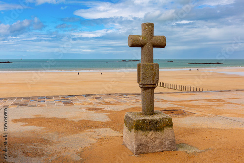 Canvastavla Stone cross on the beach promenade in Saint Malo, Brittany, with sandy shore and