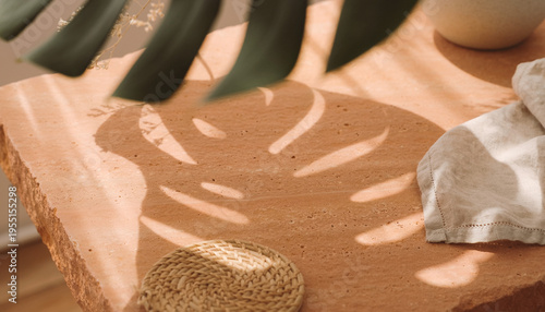 Monstera leaf shadow cast on textured earth-toned surface with linen fabric