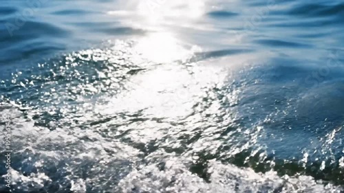 Sunlight reflecting on surface of ocean water with small waves creating beautiful bright light during summer