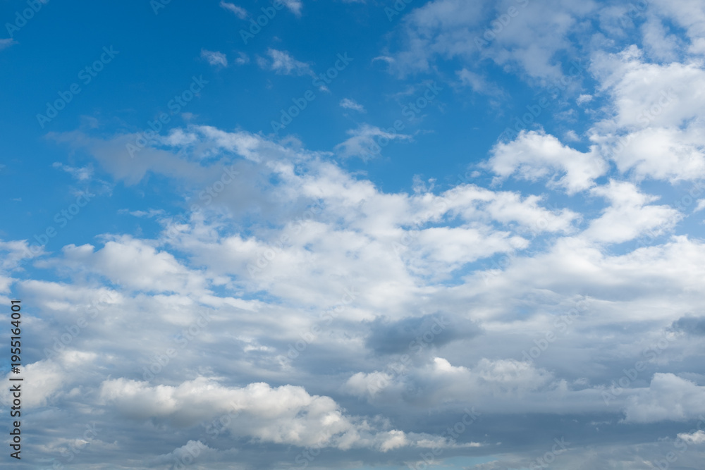 Fototapeta premium Blue sky with white clouds background, soft cloudy sky texture, sunny weather, natural atmosphere, minimal nature backdrop with copy space