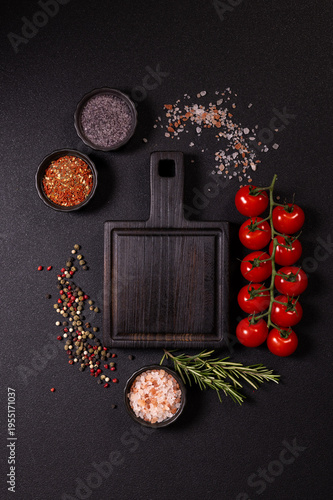 Cutting board with fresh tomatoes and various spices