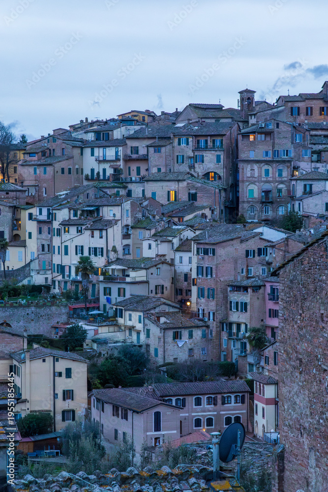 Fototapeta premium Sunset Bathes Siena In Warm Golden Hues. City Of Siena Is Illuminated By Radiant Sunset Casting Golden Reflections On Its Rooftops