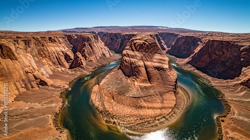 Stunning aerial view showcases the Horseshoe Bend canyon and Colorado River winding through the arid landscape under a clear blue sky