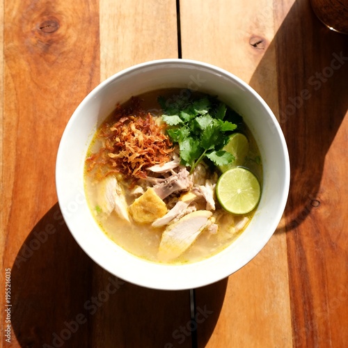 Traditional Indonesian Soto Ayam Soup with Chicken and Lime