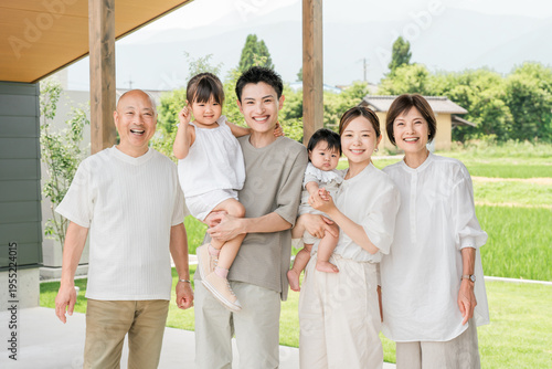 Obraz na plátne A three-generation family (two-family home) taking a family photo in front of their new home