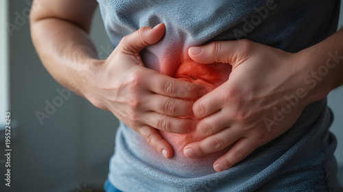 Close-up of a man clutching his abdomen due to stomach pain or cramps. Ideal for digestive health, gastrointestinal issues, abdominal discomfort, and medical awareness content.