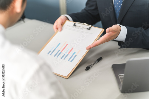 Bilde på lerret A businessman's hands as he explains something to a customer while showing them graphs and documents