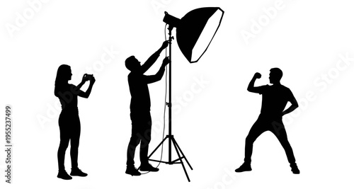 Photographer adjusts studio light while model poses and assistant photographs