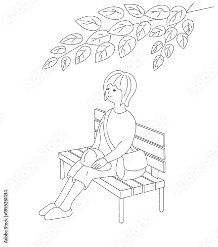 散歩の途中に公園でベンチに腰掛けてひと休みする女性