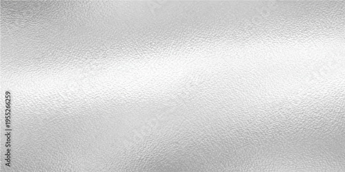 Textured silver surface creates a refined and elegant background for design. Capturing the interplay of light and shadow on the metallic surface.