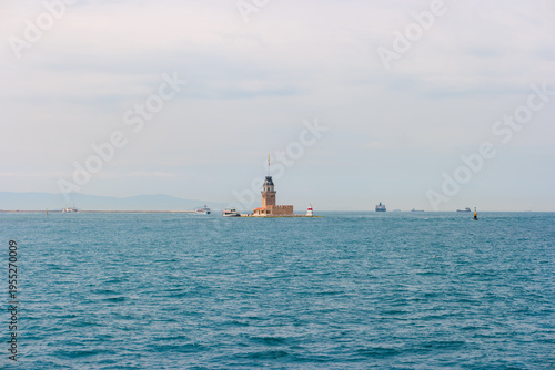 Wallpaper Mural Istanbul, Turkey. Maiden's Tower seen from afar against hazy Asian coastline, cargo vessels passing through Bosphorus entrance to Marmara Sea, summer haze softening the distant shore. Torontodigital.ca