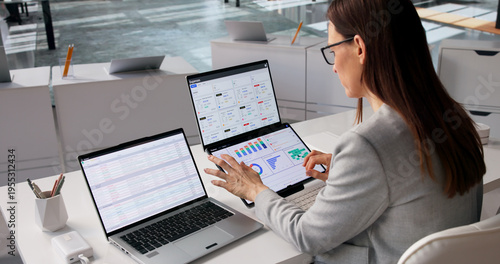 Bilde på lerret Fintech Specialist Examines Diverse Financial Dashboards