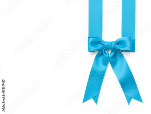 Bright cyan satin ribbon tied in a decorative bow with two vertical hanging fabric tails isolated on a plain white background