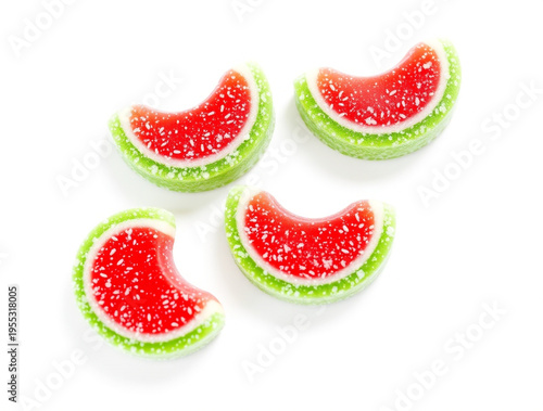 Four crescent shaped watermelon gummy candies with red centers and green rinds isolated on a white background