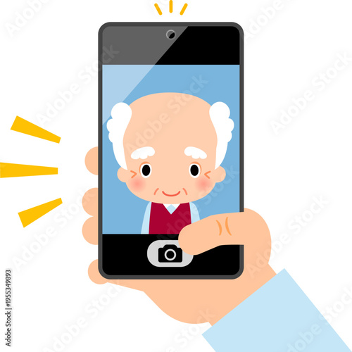 スマートフォンのインカメラでセルフィーを撮るシニア男性