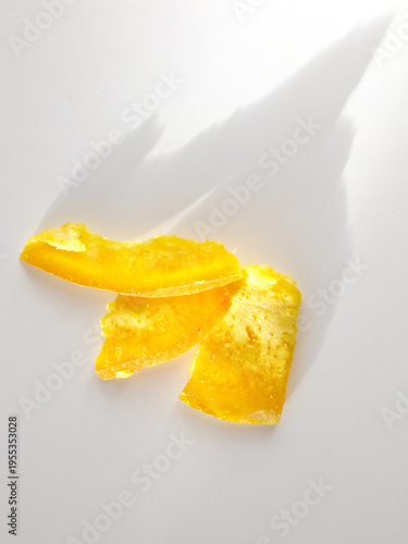 Fresh citrus rind pieces isolated on plain white