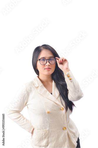 Young woman adjusting glasses in white blazer