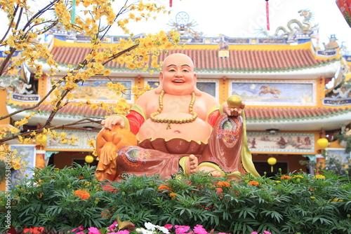 Happy Buddha outside Phap Bao Pagoda Hoi An during Tet, Vietnam