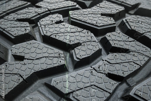 Fotografie Black tire tread texture background with detailed rubber pattern.