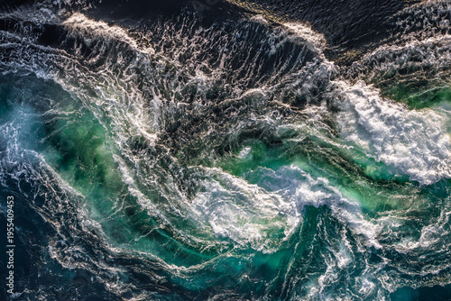 Blue waves of water of the river and the sea meet each other during high tide and low tide.