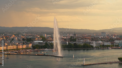 Golden evening over Geneva. Calm twilight at Geneva with reflections and mountain silhouette