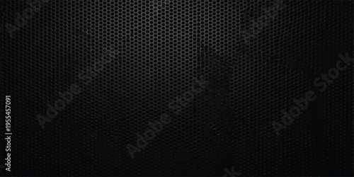 Abstract black and white textured background featuring a dark seamless pattern of metallic carbon fiber and rough paper material for a grey backdrop surface