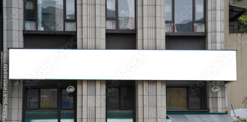 Blank billboard sign mockup in the urban environment on old building, facade, empty space to display your advertising or branding campaign