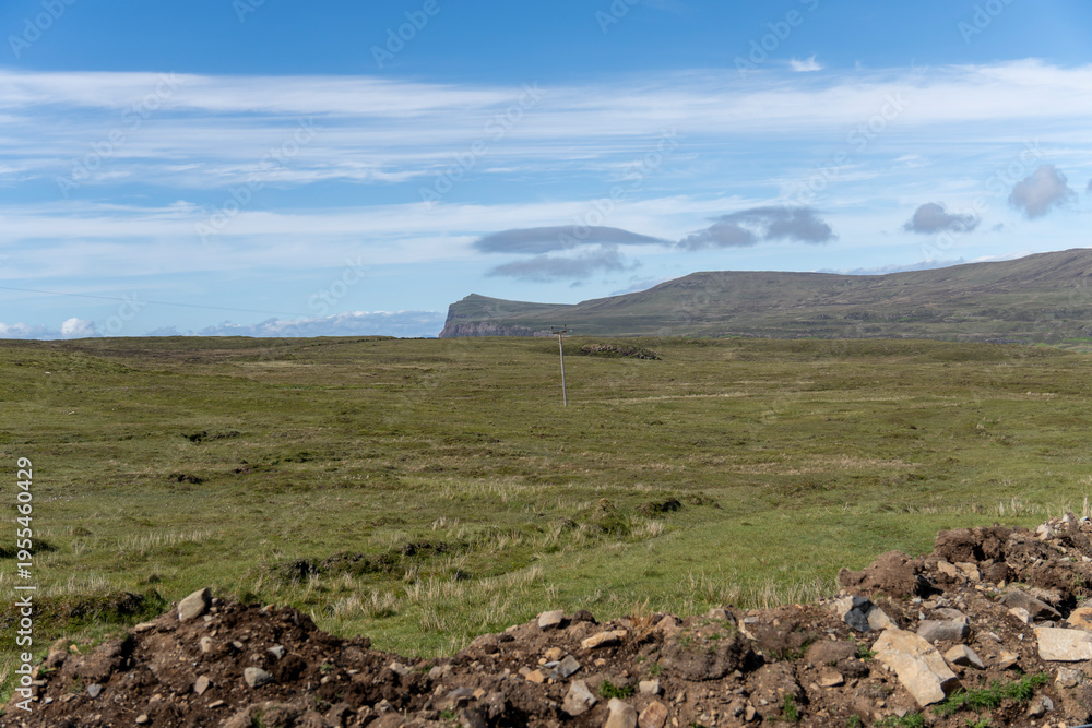 Obraz premium The Isle of Skye, is a large and scenic island in the Inner Hebrides of Scotland.Neist Point Lighthouse). Located at Duirinish Peninsula, near Glendale, is known for its imposing cliffs.