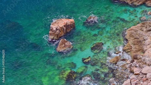 Peaceful turquoise water on the coastline rocky coastline
