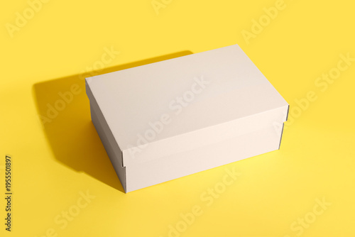 White shoebox on yellow bac...