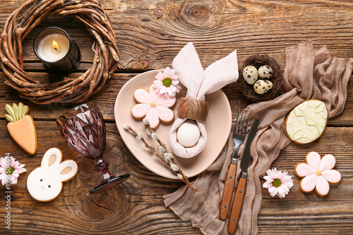 Foto Beautiful table setting with different Easter cookies, eggs, burning candle and