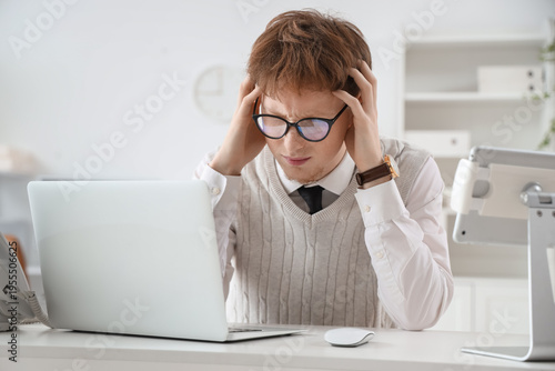 Stressed young man working ...